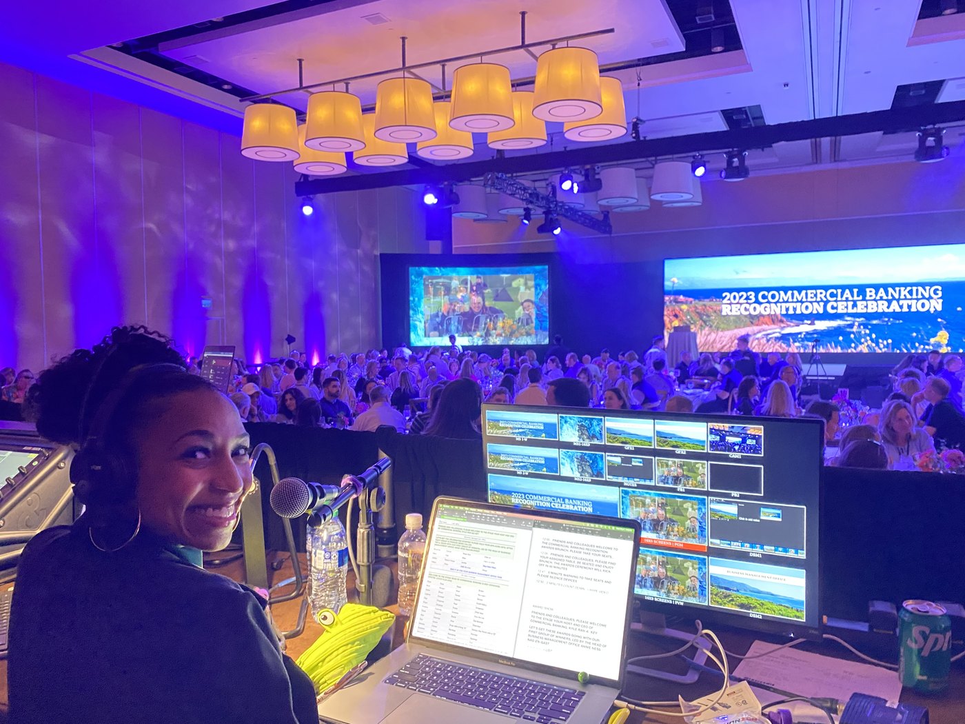 Chelsea at the Live Voice MC desk in the back of the Wells Fargo Commercial Banking Recognition Celebration ballroom