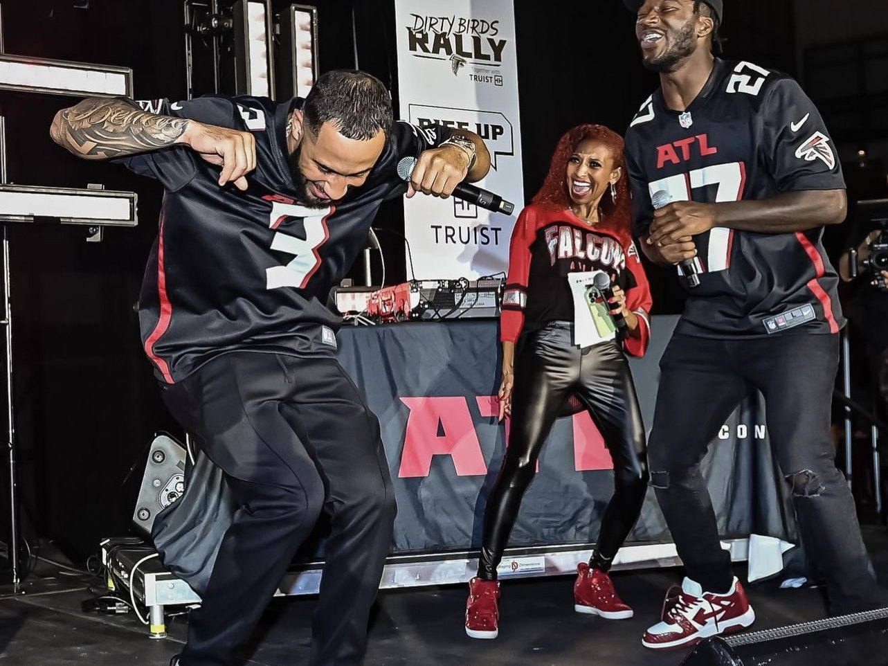 Chelsea on stage dancing with Falcons players at the Kickoff Pep Rally