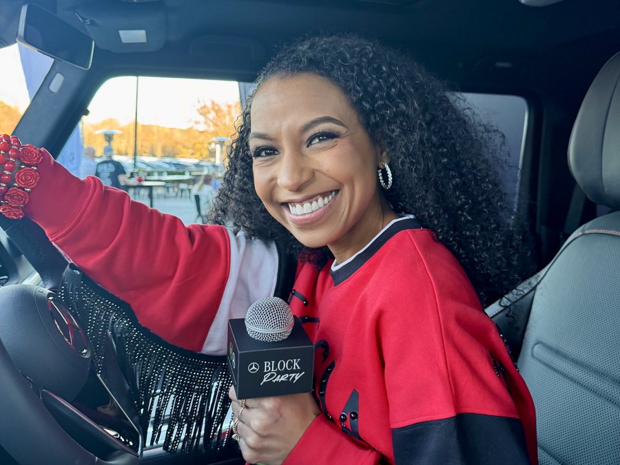 Chelsea in a Mercedes-Benz with a branded Block Party mic flag
